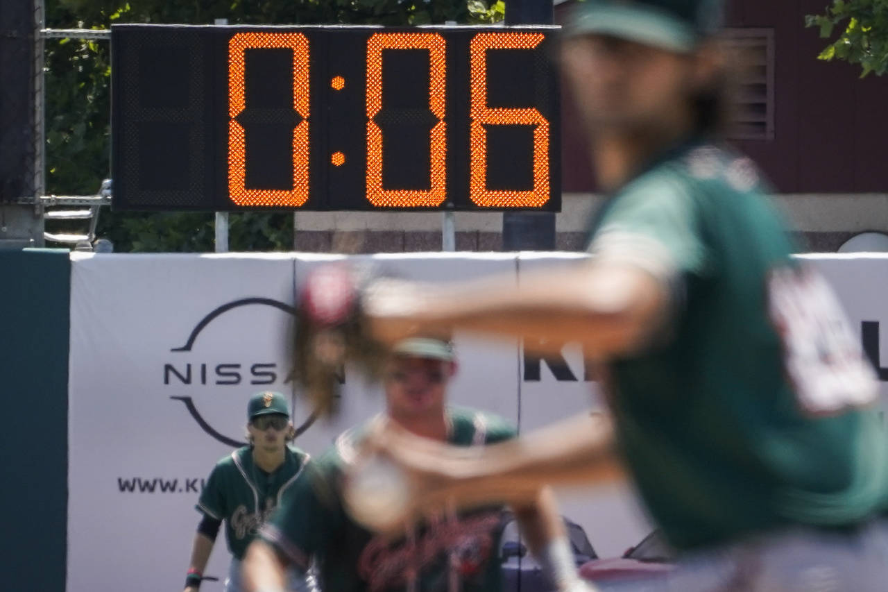 A pitch clock is deployed to restrict pitcher preparation times during a minor league baseball game...