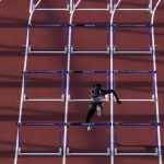 
              Anne Zagre, of Belgium, runs alone in a heat in the women's 100-meter hurdles at the World Athletics Championships on Saturday, July 23, 2022, in Eugene, Ore. Zagre in lane six got hampered during the race at the 10th hurdle by Nia Ali, of the USA in lane five. Ali of the USA knocked a hurdle over and got in lane six, affecting Zagre. (AP Photo/Gregory Bull)
            