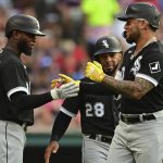 
              Chicago White Sox's Yoan Moncada, right, is congratulated by Luis Robertin, left, and Leury Garcia, center, after hitting a three-run home run off Cleveland Guardians starting pitcher Cal Quantrill in the first inning of a baseball game, Monday, July 11, 2022, in Cleveland. (AP Photo/David Dermer)
            