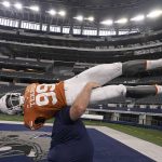 
              A mannequin wearing a Texas football uniform is carried away after the NCAA college football Big 12 media days in Arlington, Texas, Thursday, July 14, 2022. (AP Photo/LM Otero)
            
