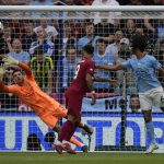 
              Manchester City's goalkeeper Ederson, left, fails to save the ball as Liverpool's Trent Alexander-Arnold scores his side's opening goal during the FA Community Shield soccer match between Liverpool and Manchester City at the King Power Stadium in Leicester, England, Saturday, July 30, 2022. (AP Photo/Frank Augstein)
            