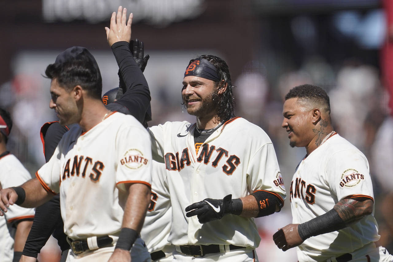 San Francisco Giants' Brandon Crawford, middle, celebrates with teammates after hitting an RBI sing...