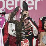 
              Christopher Bell holds up a giant lobster while celebrating with his wife, Morgan, right, after winning a NASCAR Cup Series auto race at the New Hampshire Motor Speedway, Sunday, July 17, 2022, in Loudon, N.H. (AP Photo/Charles Krupa)
            