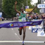 
              Tamirat Tola, of Ethiopia, celebrates after winning the men's marathon at the World Athletics Championships on Sunday, July 17, 2022, in Eugene, Ore. (AP Photo/Gregory Bull)
            