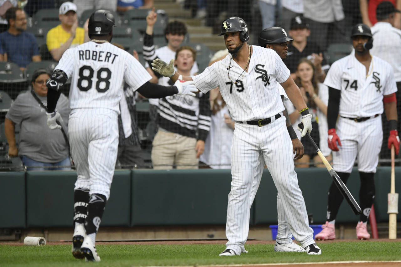 Chicago White Sox's Luis Robert (88) celebrates with Jose Abreu (79) after hitting a two-run home r...