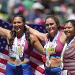 
              Gold medalist Brooke Andersen, of the United States, center, stands with silver medalist Camryn Rogers, of Canada, right, and bronze medalist Janee' Kassanavoid, of the United States, after the women's hammer throw final at the World Athletics Championships on Sunday, July 17, 2022, in Eugene, Ore. (AP Photo/Ashley Landis)
            