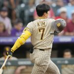 
              San Diego Padres' Ha-Seong Kim loses his batting helmet while swinging at a pitch from Colorado Rockies starting pitcher Chad Kuhl during the fourth inning of a baseball game Wednesday, July 13, 2022, in Denver. (AP Photo/David Zalubowski)
            