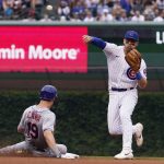 
              Chicago Cubs shortstop Nico Hoerner, right, throws out New York Mets Luis Guillorme at first base after forcing out Mark Canha at second during the sixth inning of a baseball game in Chicago, Sunday, July 17, 2022. (AP Photo/Nam Y. Huh)
            