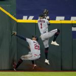 
              Minnesota Twins center fielder Byron Buxton (25) slams into the wall after catching a flyout by Texas Rangers' Marcus Semien after left fielder Nick Gordon (1) was unable to reach the ball in the fourth inning of a baseball game, Friday, July 8, 2022, in Arlington, Texas. (AP Photo/Tony Gutierrez)
            