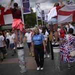 
              Supporters arrive for the final of the Women's Euro 2022 soccer match between England and Germany at Wembley stadium in London, Sunday, July 31, 2022. (AP Photo/Daniel Cole)
            