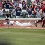 
              Atlanta Braves' Matt Olson slides safely into home on a game winning RBI from Austin Riley during the ninth inning of a baseball game, Sunday, July 31, 2022, in Atlanta. (AP Photo/Butch Dill)
            