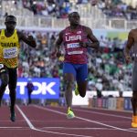 
              Christian Coleman, center, of the United States, wins a heat in the men's 100-meter run at the World Athletics Championships Friday, July 15, 2022, in Eugene, Ore. (AP Photo/Ashley Landis)
            