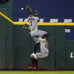 
              Minnesota Twins left fielder Nick Gordon (1) is unable to reach a flyout by Texas Rangers' Marcus Semien that center fielder Byron Buxton (25) then caught in the fourth inning of a baseball game, Friday, July 8, 2022, in Arlington, Texas. (AP Photo/Tony Gutierrez)
            