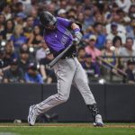 
              Colorado Rockies' Kris Bryant hits a ball to the infield, reaching first on an error by Milwaukee Brewers third baseman Luis Urias during the sixth inning of a baseball game Saturday, July 23, 2022, in Milwaukee. (AP Photo/Kenny Yoo)
            