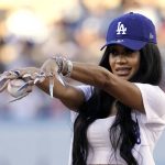 
              Entertainer Saweetie gestures before throwing out the ceremonial first pitch prior to a baseball game between the Los Angeles Dodgers and the Chicago Cubs Thursday, July 7, 2022, in Los Angeles. (AP Photo/Mark J. Terrill)
            