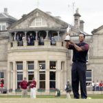 
              FILE - Tiger Woods holds the trophy as he stands in front of the clubhouse after winning the British Open golf championship on the Old Course at St. Andrews, Scotland, Sunday July 17, 2005. The Open Championship returns to the home of golf on July 14-17, 2022, to celebrate the 150th edition of the sport's oldest championship, which dates to 1860 and was first played at St. Andrews in 1873. (AP Photo/Alastair Grant, File)
            