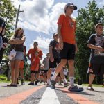 
              Cleveland Browns fans wait to enter the team facility before an NFL football practice in Berea, Ohio, Saturday, July 30, 2022. (AP Photo/David Dermer)
            