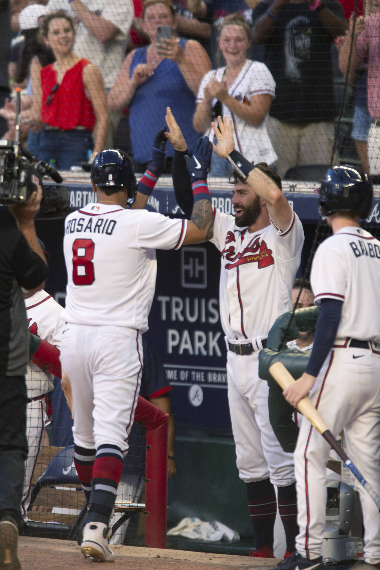 Atlanta Braves' Eddie Rosario (8) celebrates with Dansby Swanson after hitting a home run against t...