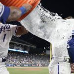 
              Kansas City Royals' Bobby Witt Jr., right, is doused by teammate MJ Melendez (1) as they celebrate a win over the Tampa Bay Rays in a baseball game Saturday, July 23, 2022, in Kansas City, Mo. (AP Photo/Ed Zurga)
            