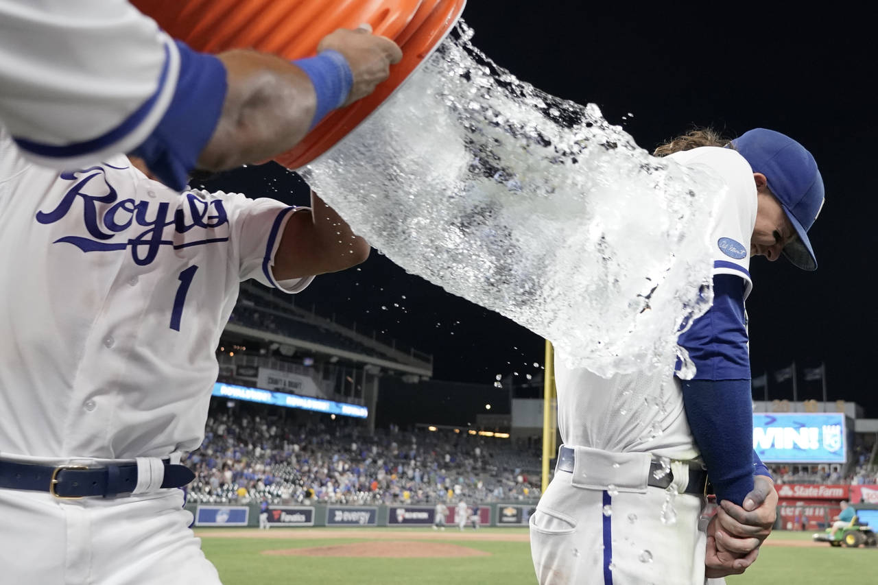 Kansas City Royals' Bobby Witt Jr., right, is doused by teammate MJ Melendez (1) as they celebrate ...