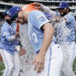 
              Kansas City Royals' Hunter Dozier (17) is doused with water by Emmanuel Rivera, left, and MJ Melendez as they celebrate a win over the Tampa Bay Rays during a baseball game Sunday, July 24, 2022, in Kansas City, Mo. (AP Photo/Ed Zurga)
            