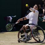 
              Shingo Kunieda of Japan serves to Britain's Alfie Hewett during the final of the men's wheelchair singles on day fourteen of the Wimbledon tennis championships in London, Sunday, July 10, 2022. (AP Photo/Alberto Pezzali)
            