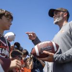 
              Cleveland Browns head coach Kevin Stefanski, right, gives autographs after an NFL football practice in Berea, Ohio, Saturday, July 30, 2022. (AP Photo/David Dermer)
            