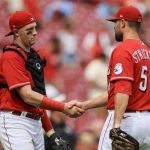 
              Cincinnati Reds' Michael Papierski, left, shakes hands with Hunter Strickland after the final out of a baseball game against the St. Louis Cardinals in Cincinnati, Sunday, July 24, 2022. (AP Photo/Aaron Doster)
            