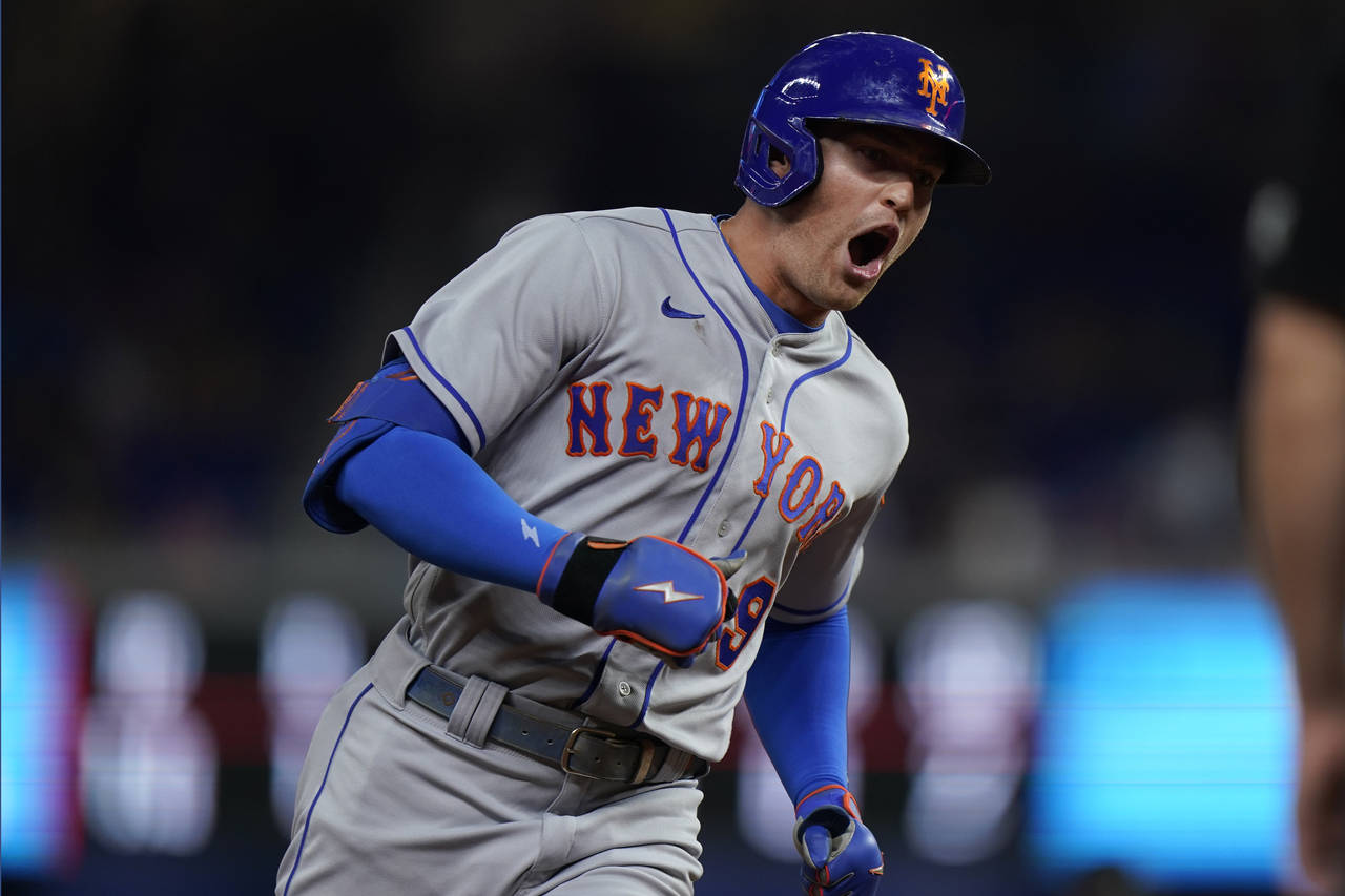 New York Mets' Brandon Nimmo celebrates as he rounds third base after hitting a home run scoring Ed...