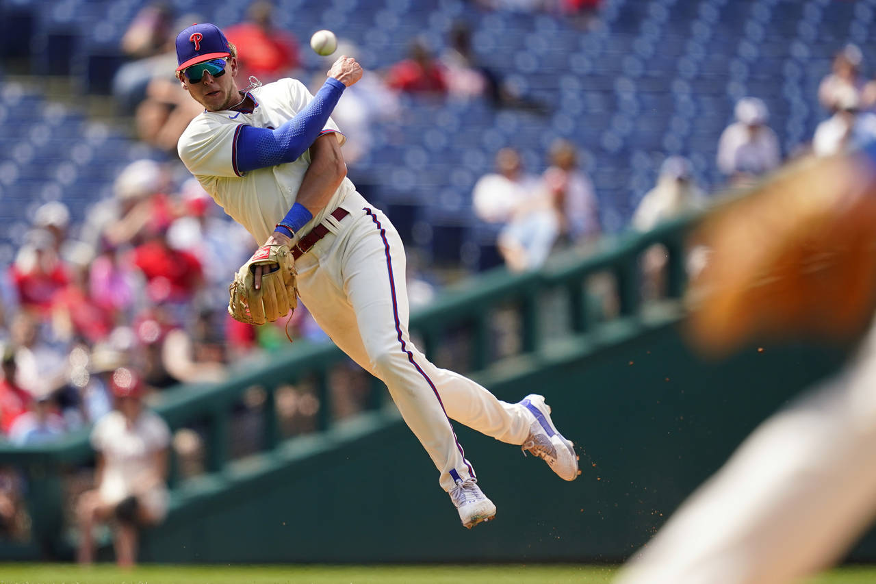 Philadelphia Phillies third baseman Alec Bohm throws to first after fielding a ground out by Atlant...