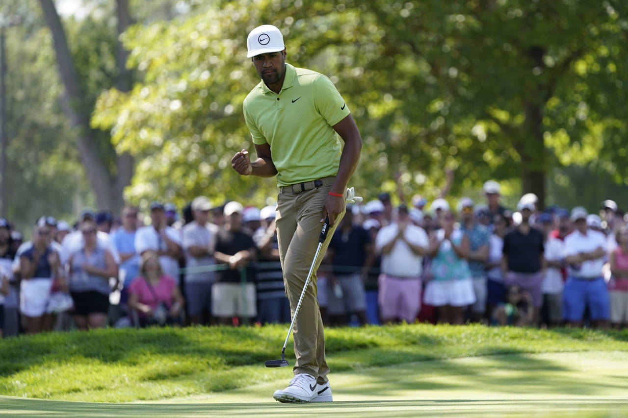 Tony Finau reacts after making his putt for par on the ninth green during the final round of the Ro...