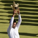 
              Serbia's Novak Djokovic celebrates with the trophy after beating Australia's Nick Kyrgios in the final of the men's singles on day fourteen of the Wimbledon tennis championships in London, Sunday, July 10, 2022. (AP Photo/Gerald Herbert)
            