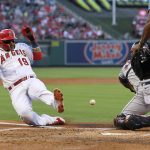 
              Los Angeles Angels' Jonathan Villar, left, scores on a single by Brandon Marsh as Houston Astros catcher Martin Maldonado takes a late throw during the second inning of a baseball game Wednesday, July 13, 2022, in Anaheim, Calif. (AP Photo/Mark J. Terrill)
            