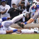 
              Chicago Cubs' Willson Contreras, left, scores on a single by Nico Hoerner as New York Mets catcher Patrick Mazeika applies a late tag during the eighth inning of a baseball game in Chicago, Sunday, July 17, 2022. The Cubs won 3-2. (AP Photo/Nam Y. Huh)
            