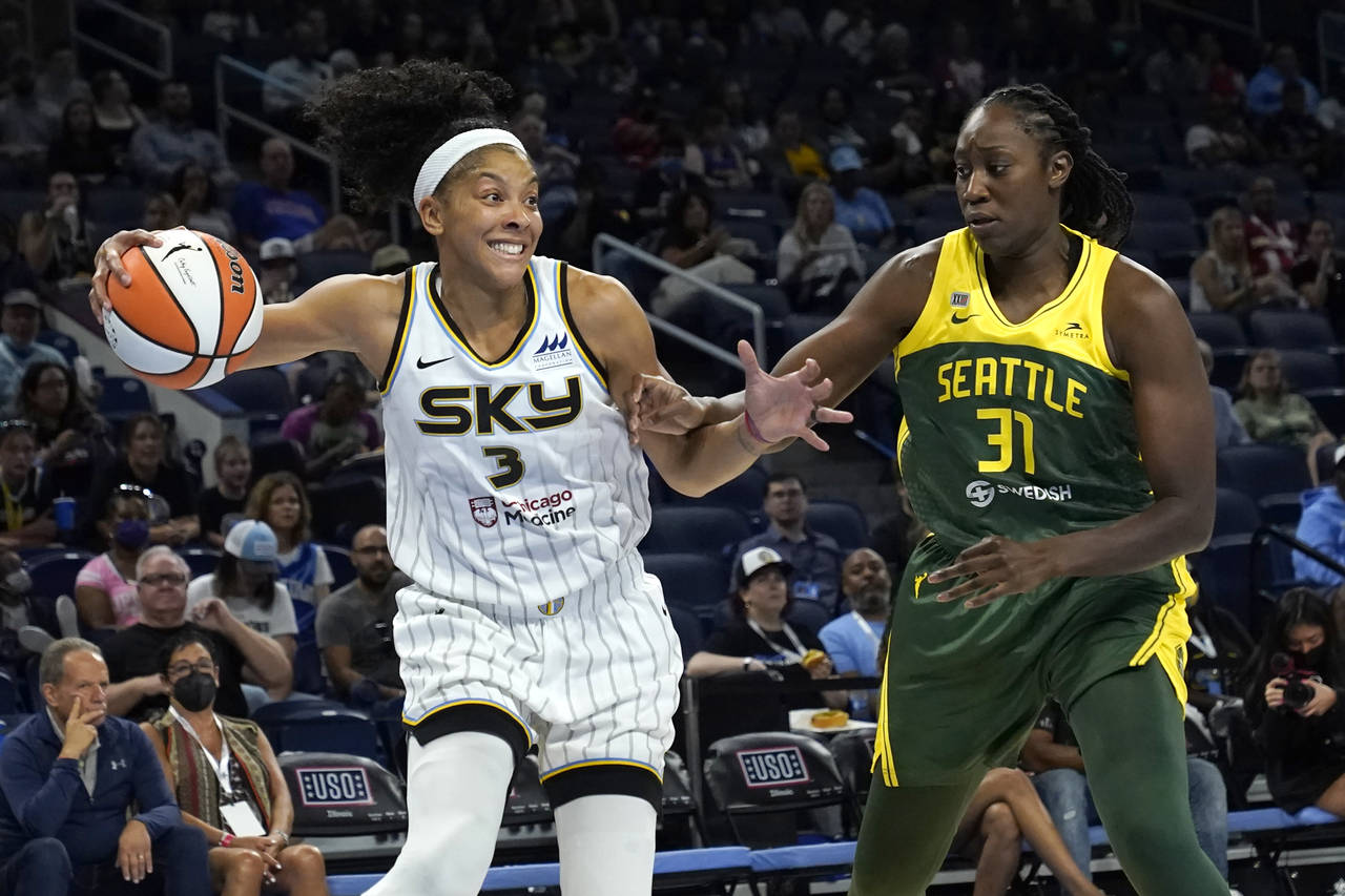 Chicago Sky's Candace Parker (3) looks to pass as Seattle Storm's Tina Charles defends during the f...