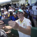 
              Australia's cricket captain Pat Cummins take selfie photos with fans after defeating Sri Lanka by ten wickets win in day three of the first test cricket match between Australia and Sri Lanka in Galle, Sri Lanka, Friday, July 1, 2022. (AP Photo/Eranga Jayawardena)
            