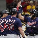 
              Minnesota Twins' Gio Urshela is congratulated bt Kyle Garlick and Jose Miranda after hitting a three-run home run during the fifth inning of a baseball game against the Milwaukee Brewers Tuesday, July 26, 2022, in Milwaukee. (AP Photo/Morry Gash)
            