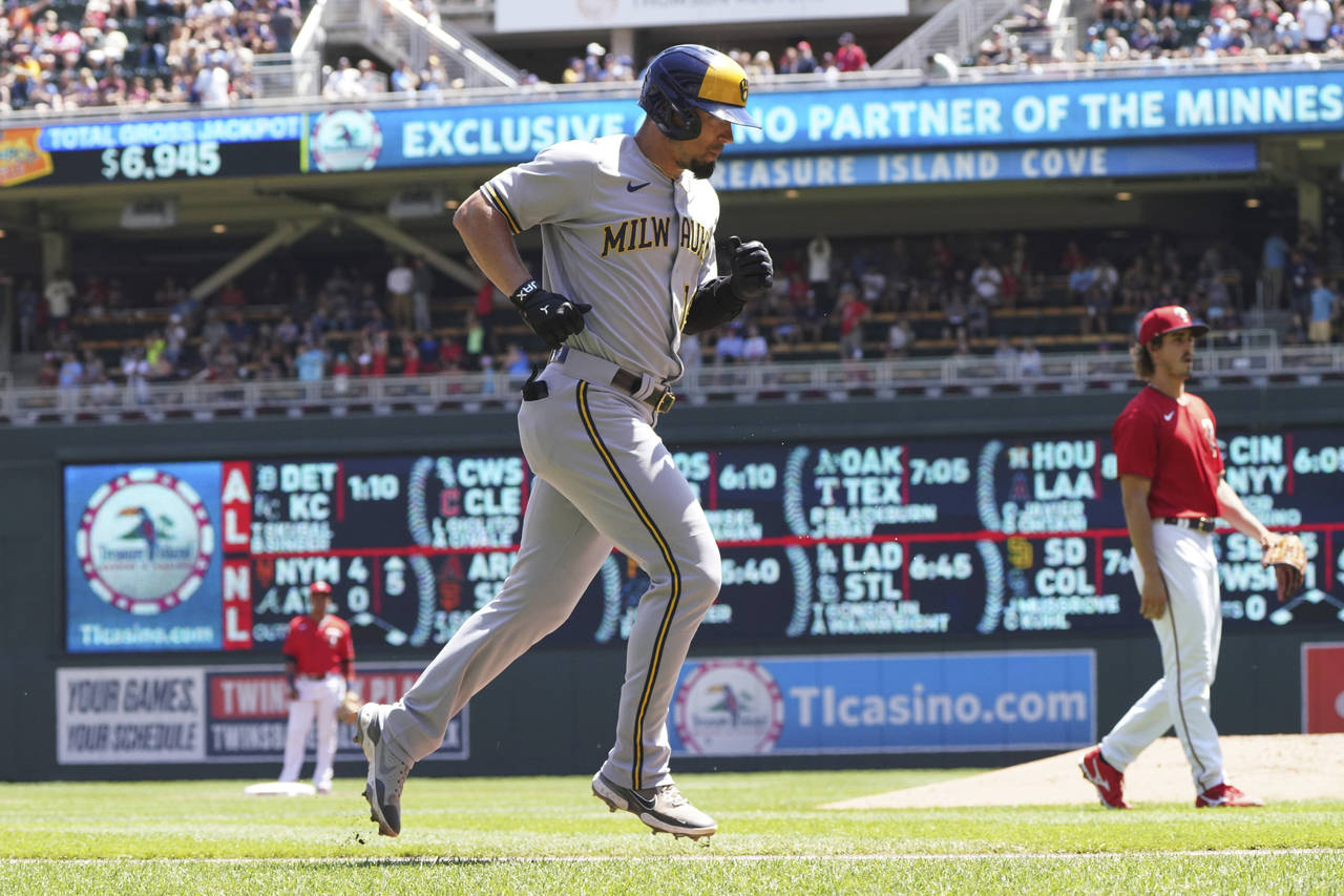 Milwaukee Brewers' Jace Peterson jogs home after hitting a solo home run off Minnesota Twins pitche...