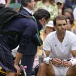 
              Spain's Rafael Nadal receives treatment just before a medical timeout as he plays Taylor Fritz of the US in a men's singles quarterfinal match on day ten of the Wimbledon tennis championships in London, Wednesday, July 6, 2022. (AP Photo/Kirsty Wigglesworth)
            