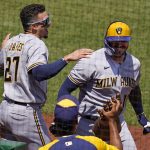 
              Milwaukee Brewers' Omar Narvaez, right, celebrates with Willy Adames (27) as he returns to the dugout after hitting a two-run home run off Pittsburgh Pirates starting pitcher Zach Thompson during the fifth inning of a baseball game in Pittsburgh, Sunday, July 3, 2022. (AP Photo/Gene J. Puskar)
            
