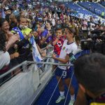 
              United States' Alex Morgan holds a child as she greats fans after defeating Jamaica 5-0 in a CONCACAF Women's Championship soccer match in Monterrey, Mexico, Thursday, July 7, 2022. (AP Photo/Fernando Llano)
            