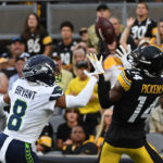 PITTSBURGH, PA - AUGUST 13: George Pickens #14 of the Pittsburgh Steelers makes a catch for a 26-yard touchdown reception as Coby Bryant #8 of the Seattle Seahawks defends in the first quarter during a preseason game at Acrisure Stadium on August 13, 2022 in Pittsburgh, Pennsylvania. (Photo by Justin Berl/Getty Images)
