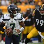 PITTSBURGH, PA - AUGUST 13: Geno Smith #7 of the Seattle Seahawks scrambles out of the pocket under pressure from Henry Mondeaux #99 of the Pittsburgh Steelers in the first quarter during a preseason game at Acrisure Stadium on August 13, 2022 in Pittsburgh, Pennsylvania. (Photo by Justin Berl/Getty Images)