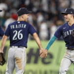 NEW YORK, NEW YORK - AUGUST 02:  Eugenio Suarez #28, Adam Frazier #26 and Sam Haggerty #0 of the Seattle Mariners celebrate after defeating the New York Yankees at Yankee Stadium on August 02, 2022 in the Bronx borough of New York City. (Photo by Jim McIsaac/Getty Images)