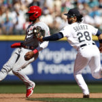 SEATTLE, WASHINGTON - AUGUST 06: Eugenio Suarez #28 of the Seattle Mariners tags out Jo Adell #7 of the Los Angeles Angels during the eighth inning at T-Mobile Park on August 06, 2022 in Seattle, Washington. (Photo by Steph Chambers/Getty Images)
