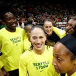 SEATTLE, WASHINGTON - AUGUST 07: Sue Bird #10 of the Seattle Storm hugs teammates before her last regular season home game of her career against the Las Vegas Aces at Climate Pledge Arena on August 07, 2022 in Seattle, Washington. (Photo by Steph Chambers/Getty Images)
