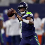 ARLINGTON, TEXAS - AUGUST 26: Quarterback Geno Smith #7 of the Seattle Seahawks looks for an open receiver against the Dallas Cowboys in the first quarter a NFL preseason football game at AT&T Stadium on August 26, 2022 in Arlington, Texas. (Photo by Tom Pennington/Getty Images)