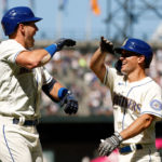 SEATTLE, WASHINGTON - AUGUST 28: Dylan Moore #25 of the Seattle Mariners celebrates his three-run home run with Adam Frazier #26 against the Cleveland Guardians in the fifth inning at T-Mobile Park on August 28, 2022 in Seattle, Washington. (Photo by Steph Chambers/Getty Images)
