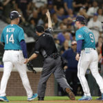 
              Plate umpire Dan Merzel tosses Seattle Mariners manager Scott Servais after he already tossed Mariners' Jesse Winker out for arguing a strike call against the Cleveland Guardians during the eighth inning of a baseball game, Friday, Aug. 26, 2022, in Seattle. (AP Photo/John Froschauer)
            