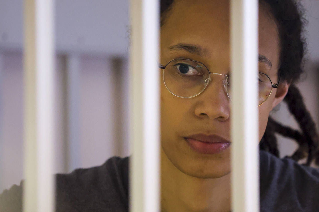 WNBA star and two-time Olympic gold medalist Brittney Griner looks through bars as she listens to t...